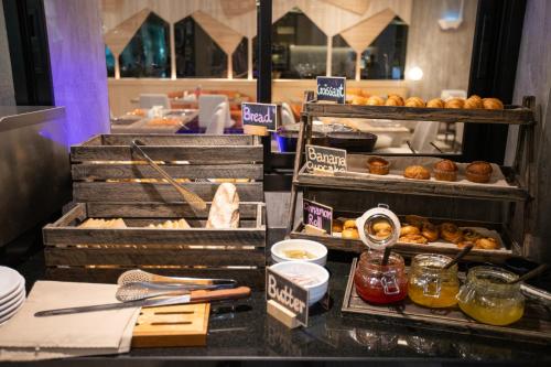 a bakery counter with pastries and other food items at PARKROYAL Suites Bangkok in Bangkok