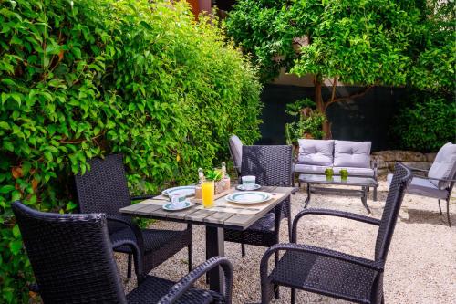a patio with a table and chairs in a yard at Alchadef Park Apartment in Rhodes Town