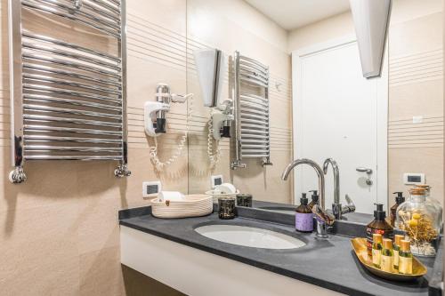 a bathroom with a sink and a mirror at Mangili Garden Hotel in Rome