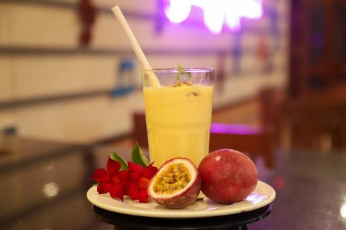 a plate of fruit and a glass of orange juice at MEDDOM Park in Cao Phong