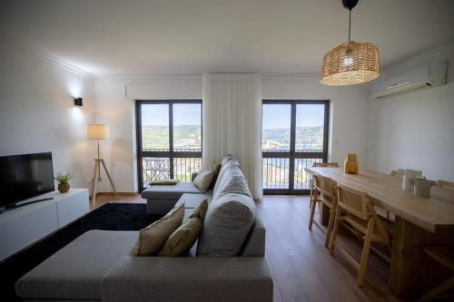 a living room with a couch and a table at Lino's Family in Peso da Régua