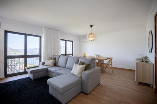 a living room with a couch and a table at Lino's Family in Peso da Régua