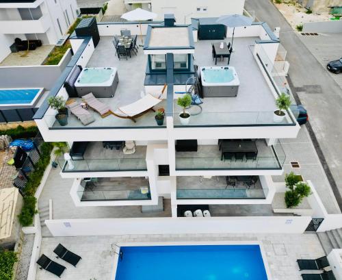 an aerial view of a house with a swimming pool at Penthouse Maus in Trogir