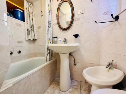 a bathroom with a sink and a toilet and a mirror at Suite Historic Centre - Sanremo in Sanremo