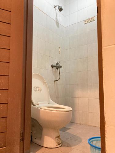 a bathroom with a toilet and a shower at Rumahku Bali Executive in Kuta