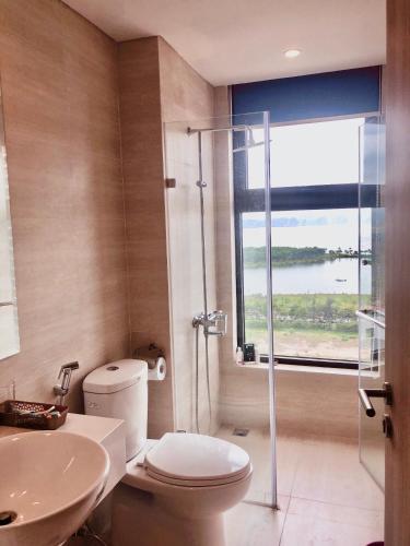 a bathroom with a shower and a toilet and a sink at Golden sunshine studio-Sea view &Nelflix Free in Ha Long