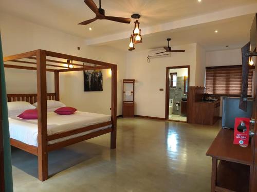 a bedroom with a bed and a ceiling fan at Cara White House in Galle