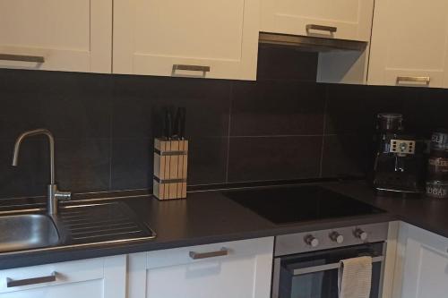 a kitchen with a sink and a counter top at Casa Anna Big House Near Lake Garda and Centre in Salò