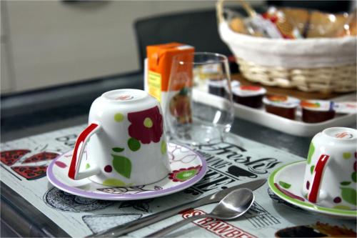 a table with two cups and plates on a table at RB Della Torre in Porretta Terme