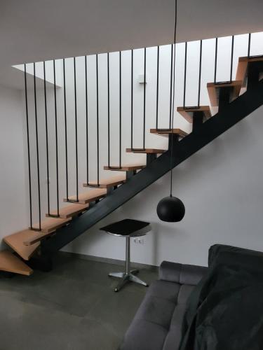 a living room with a couch and a staircase at Penthouse Maus in Trogir