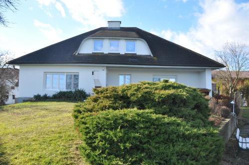 a white house with a black roof at Vermieterei in Oberwölbling