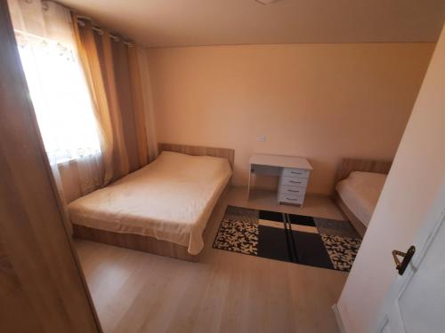 a small room with two beds and a window at Salute guest house in Kaji-Say