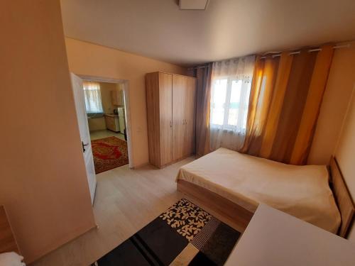a small bedroom with a bed and a hallway at Salute guest house in Kaji-Say
