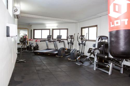 a gym with a bunch of treadmills and machines at Residence Le Carat Bonapriso in Douala