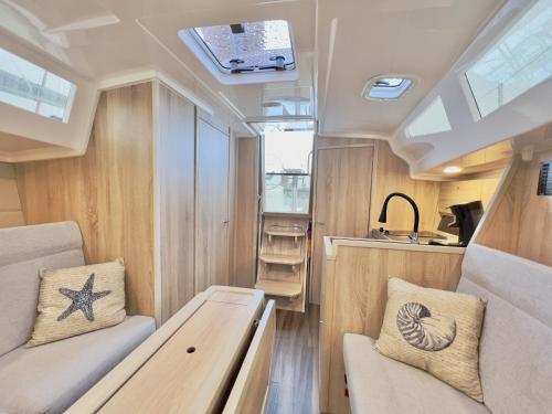 a view of the interior of a recreational vehicle with a table at Hausboot Segelyacht Nui in Burgtiefe auf Fehmarn 