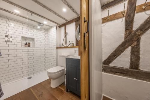 a bathroom with a toilet and a sink at Well Green Cottage in Wenhaston