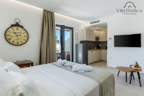 a bedroom with a large bed with a clock on the wall at Villa Basilica Tefsia in Perivolos