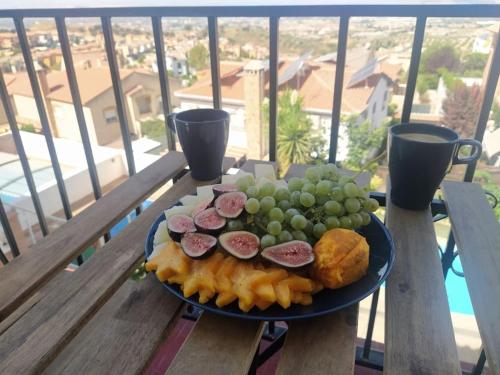 a plate of food on a table on a balcony at Luminosa y confortable casa con vistas y piscina in Jun