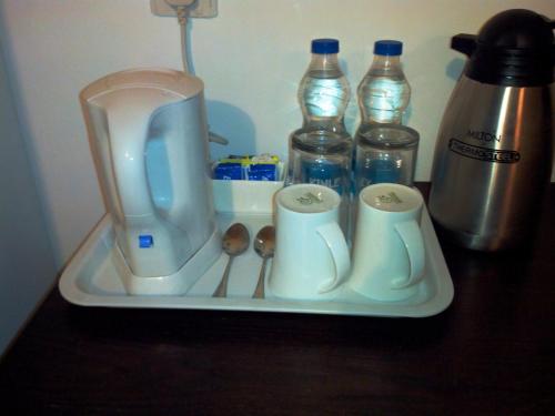 a tray with a blender and spoons and bottles of water at Springs Hotels and Spa in Bengaluru