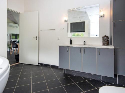 a bathroom with a sink and a toilet at Holiday home Ansager XXXVI in Ansager