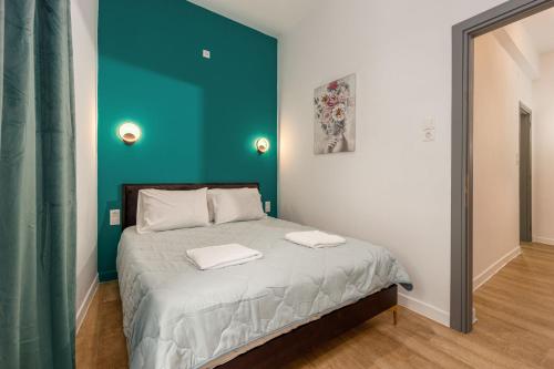 a bedroom with a bed with two towels on it at Central Art Maisonette by Estia in Heraklio Town