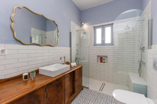 a bathroom with a sink and a mirror at Central Art Maisonette by Estia in Heraklio Town