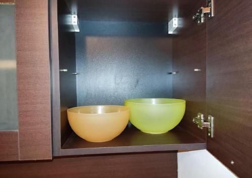 two large bowls sitting on a shelf in a bathroom at Kims One-bed Apart for rent at Sunny Beach Resort in Sunny Beach