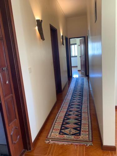 a hallway with a rug on the floor in a house at Casa Pedravedra in Mondim de Basto