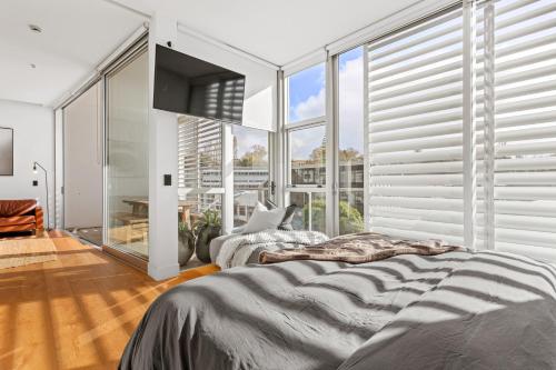 a bedroom with two beds and a large window at Luxury 2 bed2bath penthouse Free secure carpark in Auckland