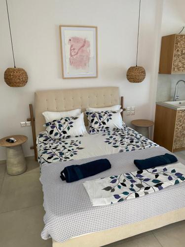 um quarto com uma cama grande com lençóis azuis e brancos em ANAX SUITE em Pera Gyalos