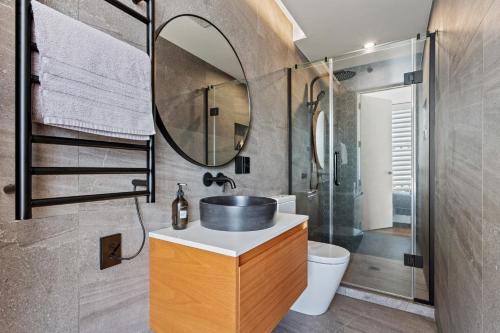 a bathroom with a sink and a mirror at Luxury 2 bed2bath penthouse Free secure carpark in Auckland