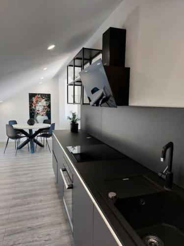 a kitchen with a sink and a table with chairs at Penthouse Petra with hot tub in Kali