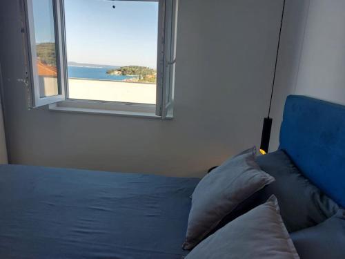 a bedroom with a bed with a view of the beach at Penthouse Petra with hot tub in Kali