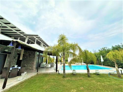 una casa con piscina y palmeras en White Diamond Villa, en Kamena Vourla