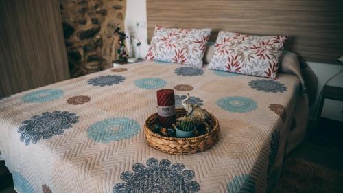 a bed with a bottle of wine and a basket on it at Cielo y mar in Marín