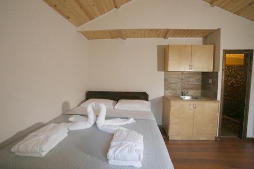 a bedroom with a bed with white towels on it at Captain Ikaros in Agios Kirykos