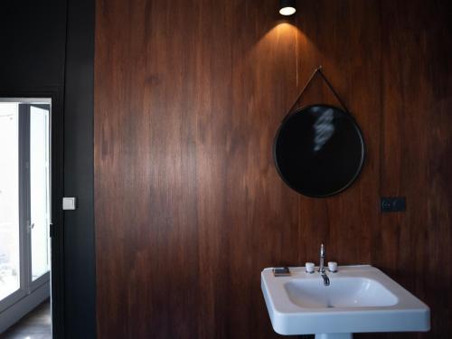 a bathroom with a sink and a mirror on the wall at La maison odette in Aulas