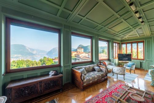 a living room with a couch and large windows at Family Villa with Stunning Lake View by Wonderful Italy in Civenna