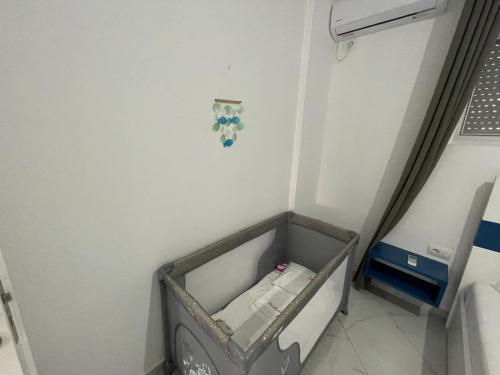 a small hospital room with a crib in the corner at Sky Apartments in Sarandë
