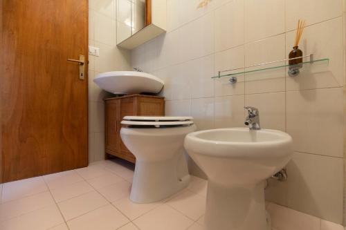 a bathroom with a toilet and a sink at Appartamento Per Due by HelloElba in Portoferraio