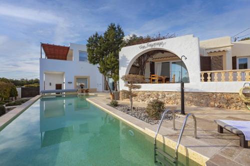 a villa with a swimming pool and a house at Villa Nubita in Sant Josep de Sa Talaia