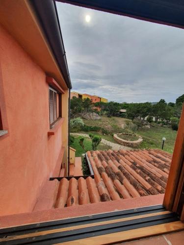 a view from a window of a roof at Monolocale Porto Coda Cavallo in Capo Coda Cavallo