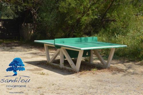 a green ping pong table sitting on the ground at Mobilhome «La mouette rieuse» * 6 personnes *Climatisatisé *2 Chambres in Sigean