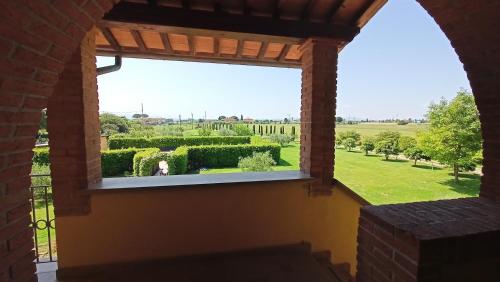 a view from a window of a garden at il Chiassetto Agriturismo No Kids in Cascina