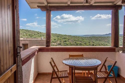 a table and chairs on a balcony with a view at Village Cugnana Verde Lovely Apt -Terrace&Parking! in Cugnana Verde