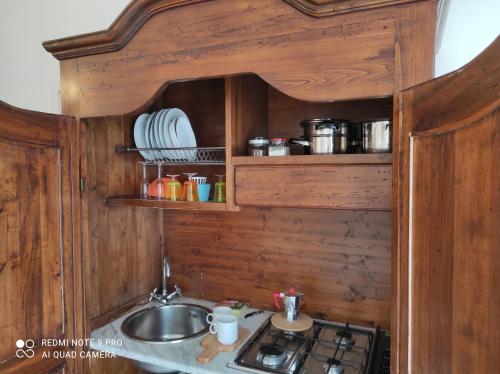 a kitchen with a sink and a stove at Monolocale Sirena vista mare in San Marco di Castellabate