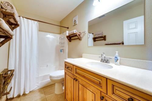 a bathroom with a sink and a toilet and a mirror at South Lake Tahoe Home with Deck and Gas Grill! in South Lake Tahoe