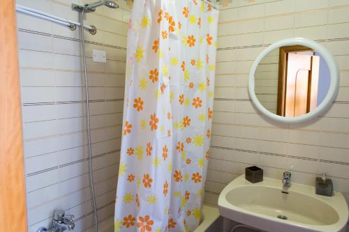 a bathroom with a shower curtain and a sink at Agrigento CityCenter in Agrigento