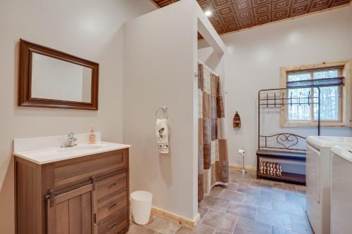 a bathroom with a sink and a shower with a mirror at Pet-Friendly Cabin Retreat Walk to Lake Pepin! in Stockholm