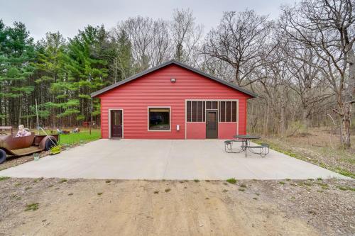 a red barn with a table in front of it at Pet-Friendly Cabin Retreat Walk to Lake Pepin! in Stockholm